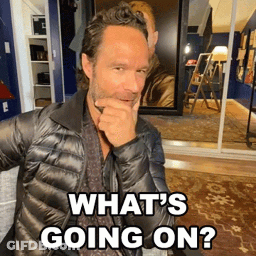 A Man In A Black Jacket With The Words What 'S Going On Behind Him GIF