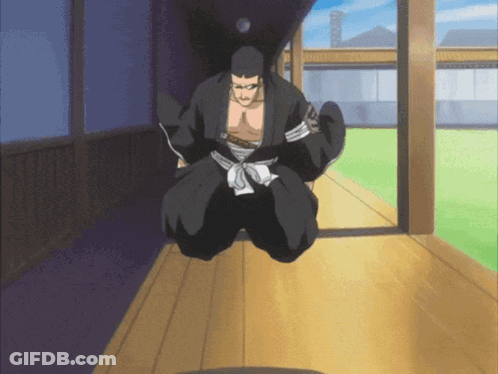 A Man In A Black Kimono Is Kneeling Down On A Wooden Floor GIF