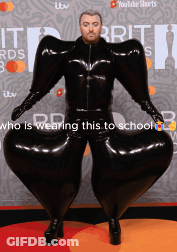 A Man In A Black Latex Suit Is Wearing A Youtube Shorts Ad Behind Him GIF