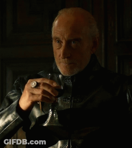 A Man In A Black Leather Jacket Holds A Glass Of Wine GIF