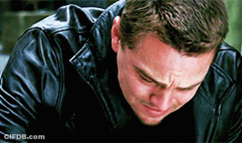 A Man In A Black Leather Jacket Is Crying While Looking Down . GIF