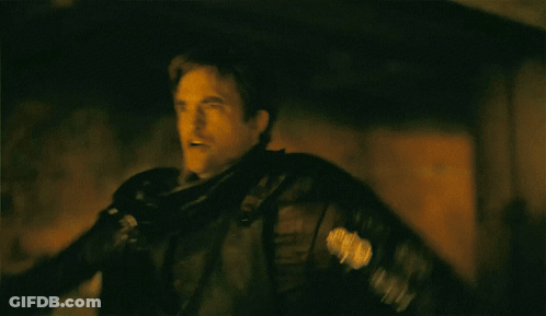 A Man In A Black Leather Jacket Is Flying In The Air GIF