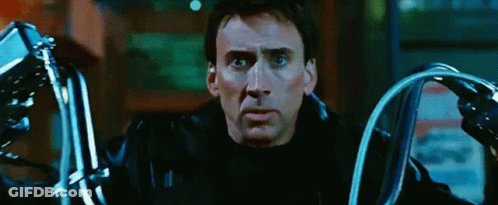 A Man In A Black Leather Jacket Is Holding A Pair Of Motorcycle Handlebars GIF