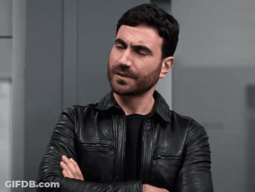 A Man In A Black Leather Jacket Is Making A Face GIF