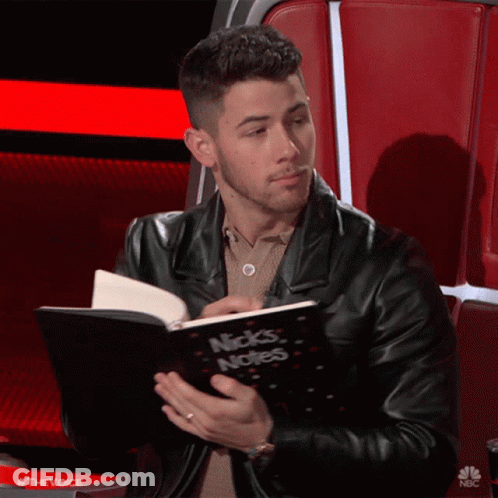 A Man In A Black Leather Jacket Is Reading A Book Called Nick 'S Notes GIF