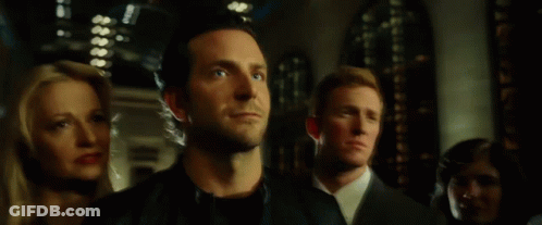A Man In A Black Leather Jacket Is Standing In A Crowd Of People GIF