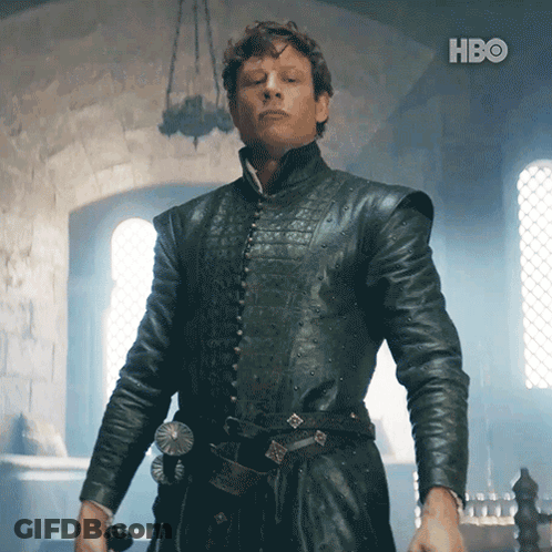 A Man In A Black Leather Jacket Is Standing In Front Of A Hbo Logo GIF