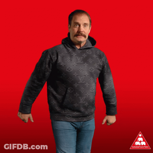 A Man In A Black Louis Vuitton Hoodie Gives Two Thumbs Up In Front Of A Red Background GIF