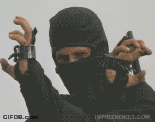 A Man In A Black Mask Is Holding A Gun With Haydiroket.com Written On The Bottom Right GIF