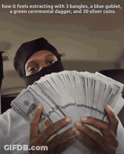 A Man In A Black Mask Is Holding A Stack Of Money And A Green Ceremonial Dagger GIF