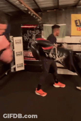 A Man In A Black Nike Shirt Is Boxing GIF