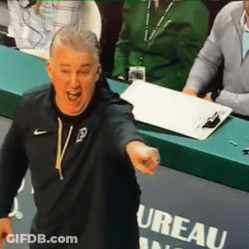 A Man In A Black Nike Sweatshirt Stands In Front Of A Sign That Says Ureau GIF