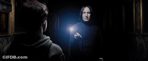 A Man In A Black Robe Is Pointing At Another Man GIF