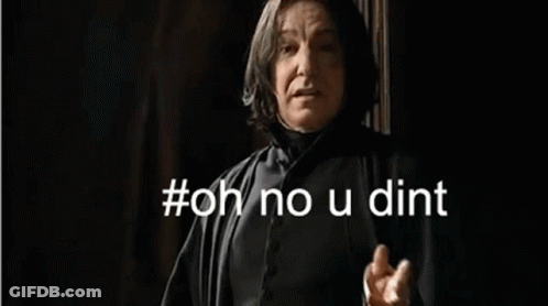 A Man In A Black Robe Is Standing In Front Of A Wall . GIF
