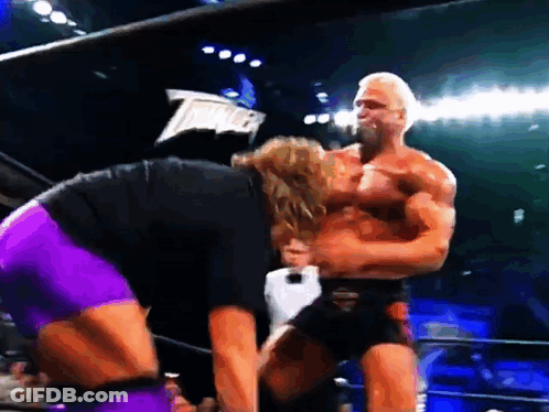 A Man In A Black Shirt And Purple Shorts Is Standing Next To A Man In A Black Shirt And Purple Shorts GIF