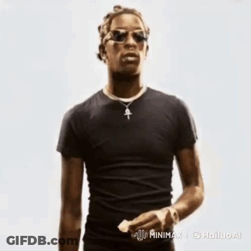 A Man In A Black Shirt And Sunglasses Is Holding A Piece Of Paper . GIF