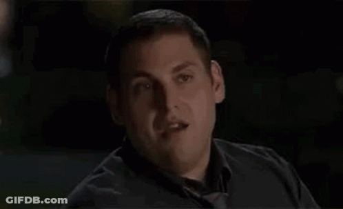 A Man In A Black Shirt And Tie Is Making A Funny Face And Saying Okay Okay Okay . GIF