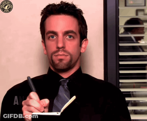 A Man In A Black Shirt And Tie Is Writing In A Notebook With A Starbucks Logo In The Corner GIF