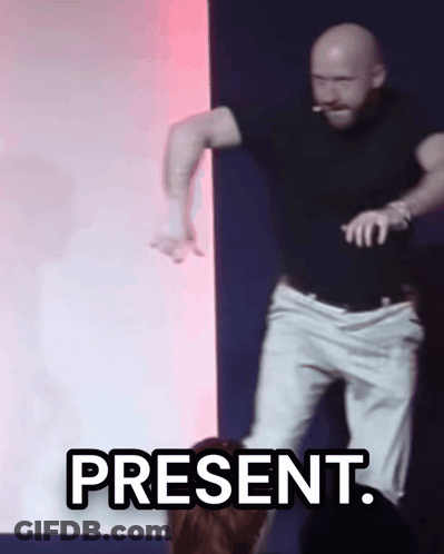 A Man In A Black Shirt And White Pants Is Dancing With The Word Present Above Him GIF