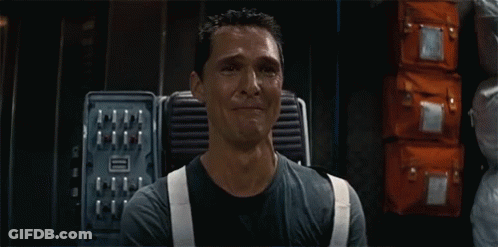 A Man In A Black Shirt And White Suspenders Is Crying In A Room GIF