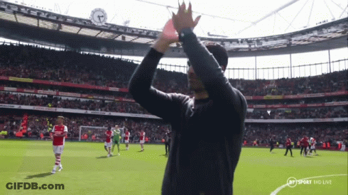 A Man In A Black Shirt Applauds The Crowd At A Soccer Game Sponsored By Bt Sport Hd Live GIF