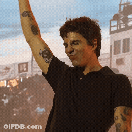 A Man In A Black Shirt Has A Tattoo On His Arm That Says ' A ' On It GIF