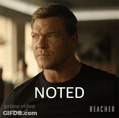 A Man In A Black Shirt Has The Word Noted On His Shirt GIF