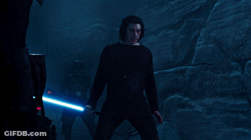 A Man In A Black Shirt Holds A Blue Light Saber GIF