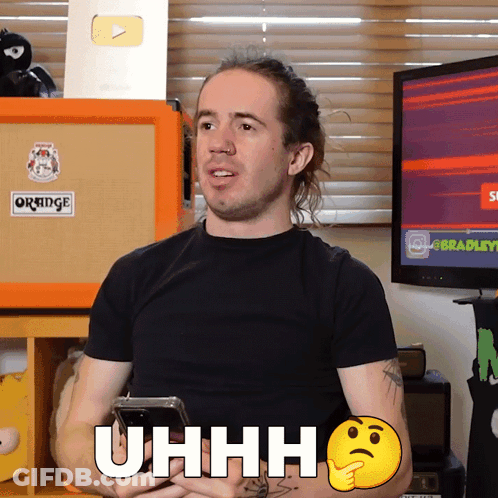 A Man In A Black Shirt Holds A Cell Phone And Says Uhh GIF