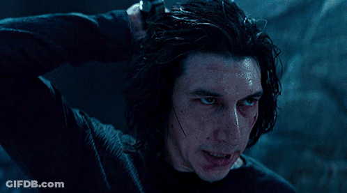 A Man In A Black Shirt Holds A Light Saber GIF