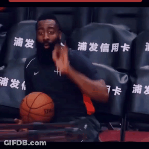 A Man In A Black Shirt Holds A Spalding Basketball In His Lap GIF