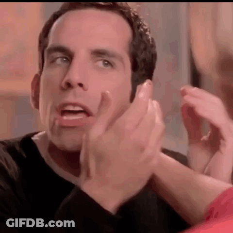 A Man In A Black Shirt Is Clapping His Hands In A Close Up Of His Face . GIF