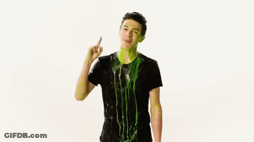 A Man In A Black Shirt Is Covered In Green Slime And Dancing . GIF