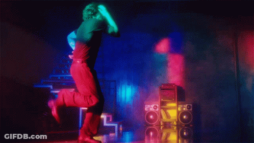 A Man In A Black Shirt Is Dancing In Front Of A Stack Of Speakers With The Letter O On Them GIF