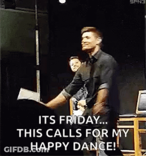 A Man In A Black Shirt Is Dancing On A Stage . GIF