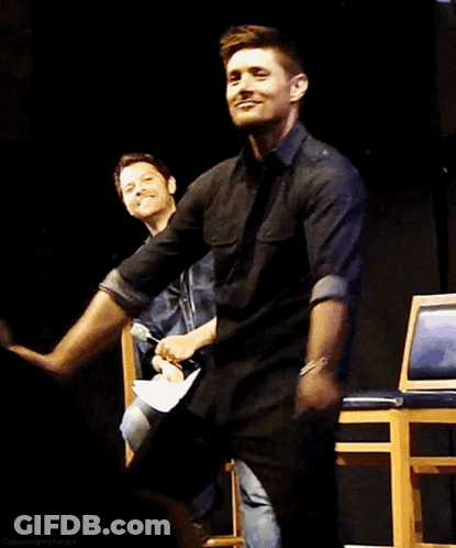 A Man In A Black Shirt Is Dancing With Another Man In A Blue Shirt GIF