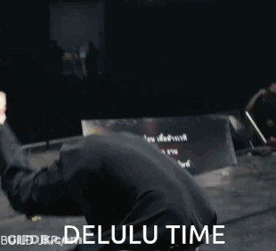 A Man In A Black Shirt Is Doing A Handstand With The Words Build Jkp Delulu Time Behind Him GIF