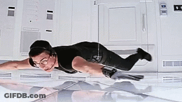 A Man In A Black Shirt Is Flying Through The Air . GIF