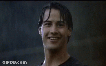A Man In A Black Shirt Is Giving A Thumbs Up In The Rain . GIF