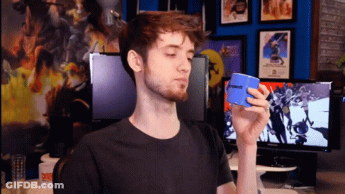 A Man In A Black Shirt Is Holding A Blue Microsoft Box GIF
