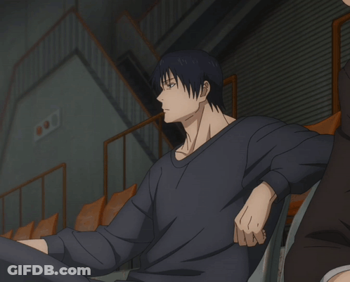 A Man In A Black Shirt Is Holding A Condom GIF