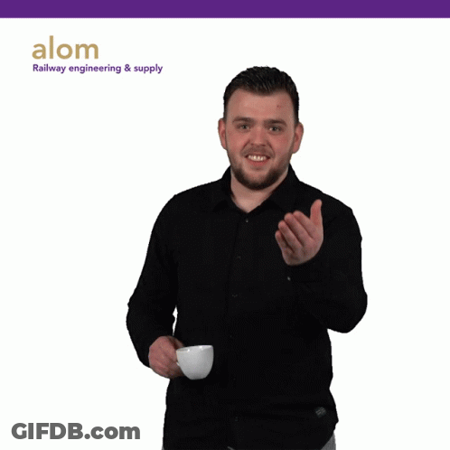 A Man In A Black Shirt Is Holding A Cup Of Coffee In Front Of A Sign That Says Alom GIF