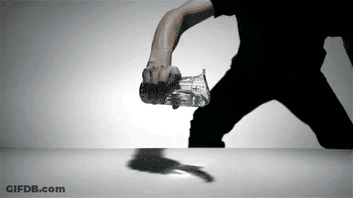 A Man In A Black Shirt Is Holding A Glass With The Word Coca Cola On It GIF