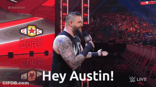 Man In Black Shirt Holding Microphone Saying Hey Austin GIF