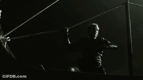 A Man In A Black Shirt Is Holding A Rope GIF