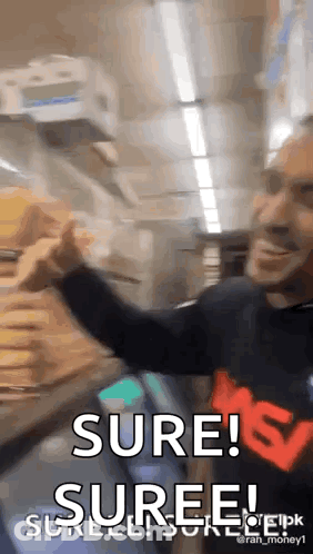A Man In A Black Shirt Is Holding A Stack Of Money And Says Sure ! Suree ! GIF