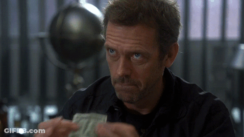 A Man In A Black Shirt Is Holding A Stack Of Money In His Hands GIF