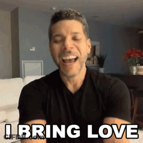 A Man In A Black Shirt Is Laughing And Saying I Bring Love . GIF