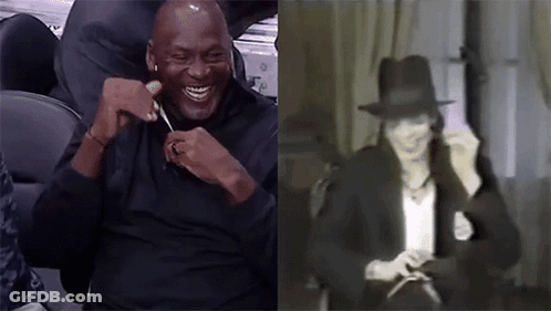 A Man In A Black Shirt Is Laughing Next To A Picture Of Michael Jackson . GIF