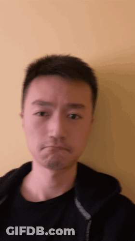 A Man In A Black Shirt Is Making A Face GIF
